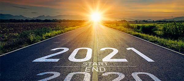 2020 turning to 2021 on a road heading to the sunrise