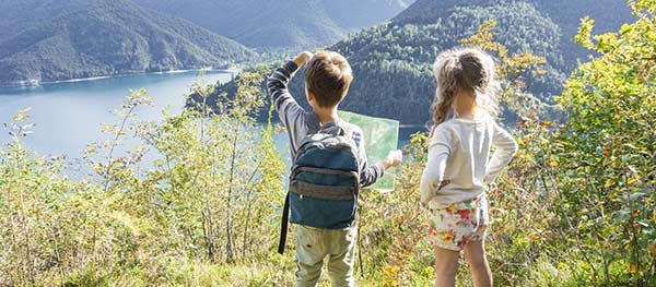 Two young kids walking in a field