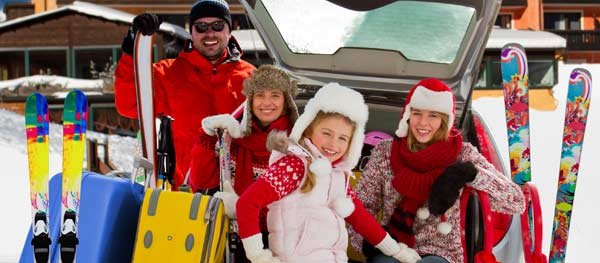 Family outside getting ready to go skiing