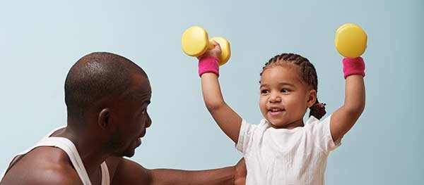 Dad and small child holding small hand weights