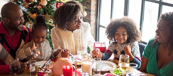 Family sitting around Christmas dinner table
