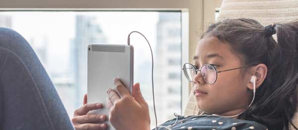 Young girl playing on a iPad