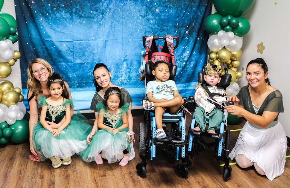 Group of small children at recital in costumes with teachers