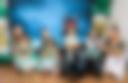 Group of small children at recital in costumes with teachers
