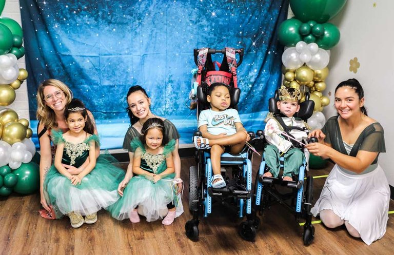 Group of small children in costumes with teacher