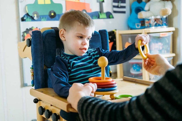 Small boy doing therapy in a chair