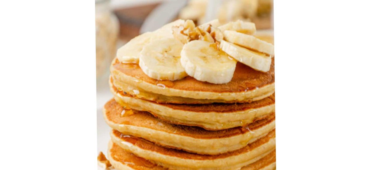 Stack of pancakes with fresh banana slices on top