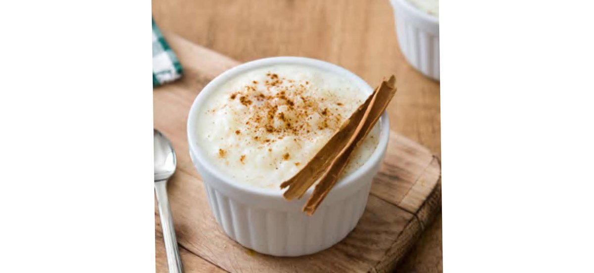 Bowl of rice pudding with cinnamon sticks