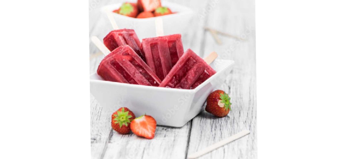 Bowl with Strawberry Popsicles with fresh strawberries for decoration