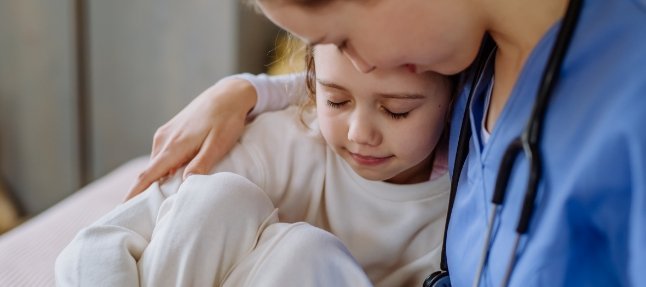 Nurse comforting small child