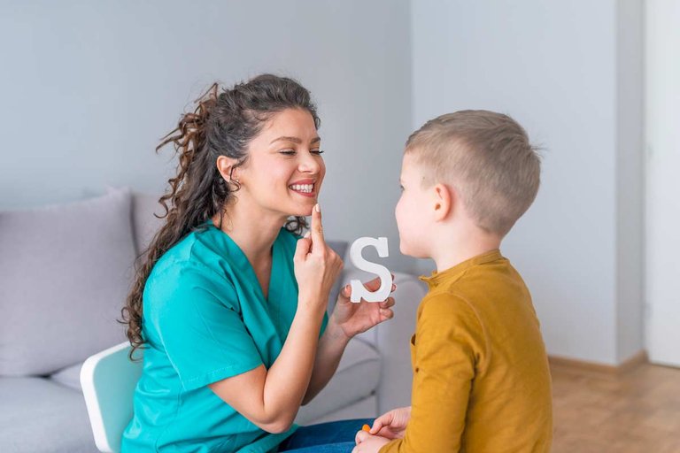 Nurse working with child to speak
