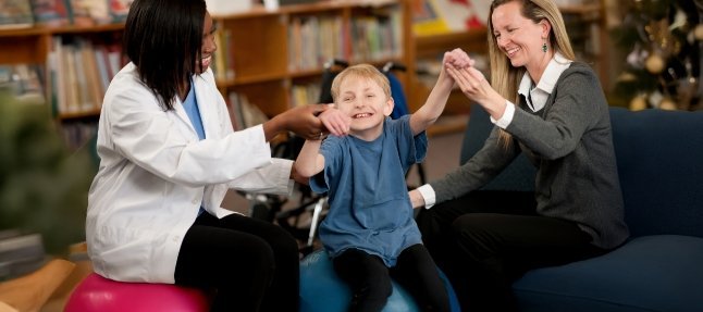 Nurse and parent interacting with small child
