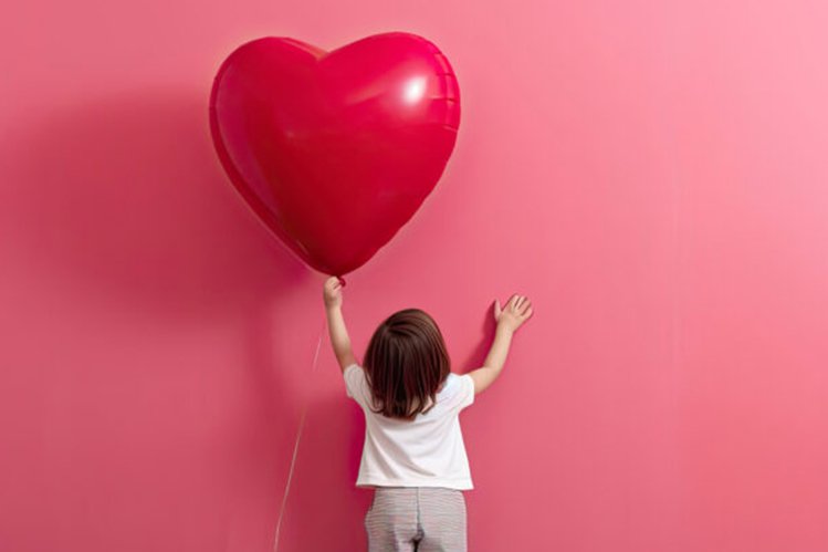 Little girl with a Valentine's heart balloon